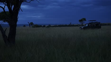 4x4 vehicle stationary on dangerous night safari adventure, african nature in maasai mara national reserve, kenya, africa safari in masai mara north conservancy