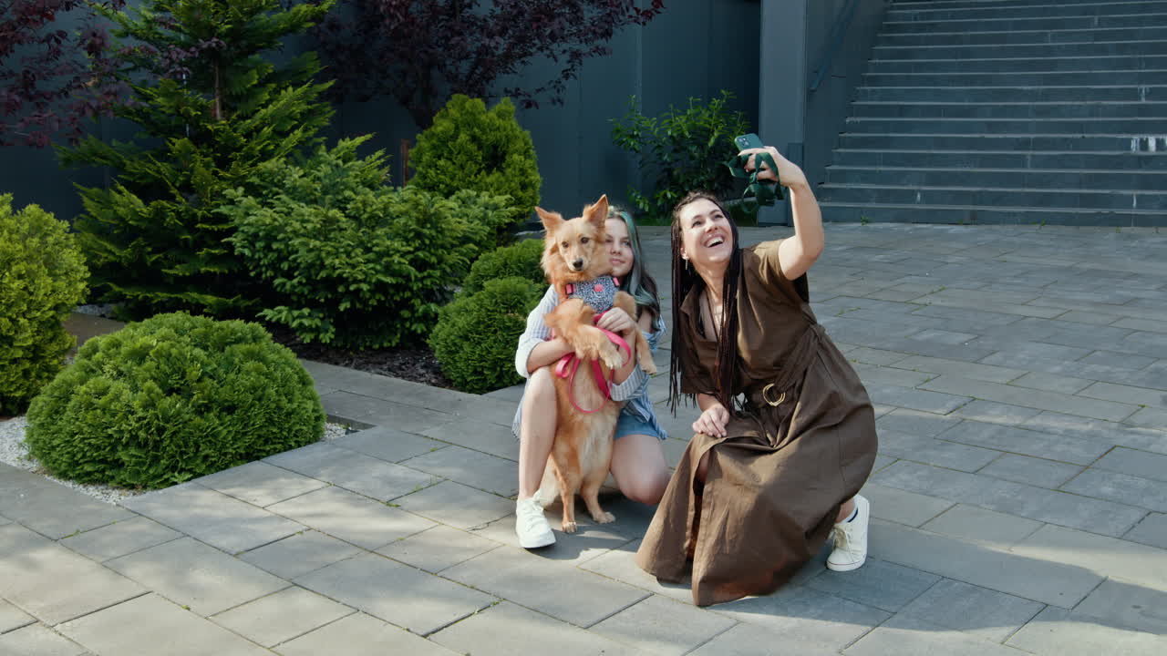 Women taking selfie with dog outside