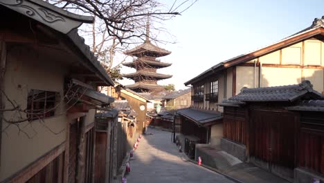 reveal to the right of a popular wooden pagoda in kyoto early morning with no people around