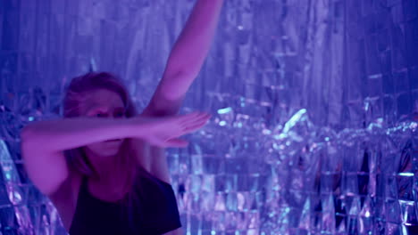 woman performing expressive contemporary dance under multicolored neon lights