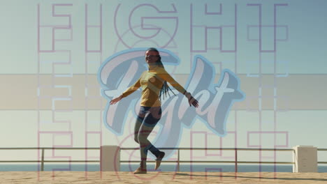 digital composite video of fight text against african american woman spinning on the promenade