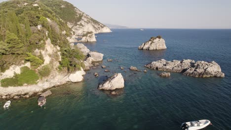 coastal scenery of parga, greece island, rocks and cliffs on calm sea