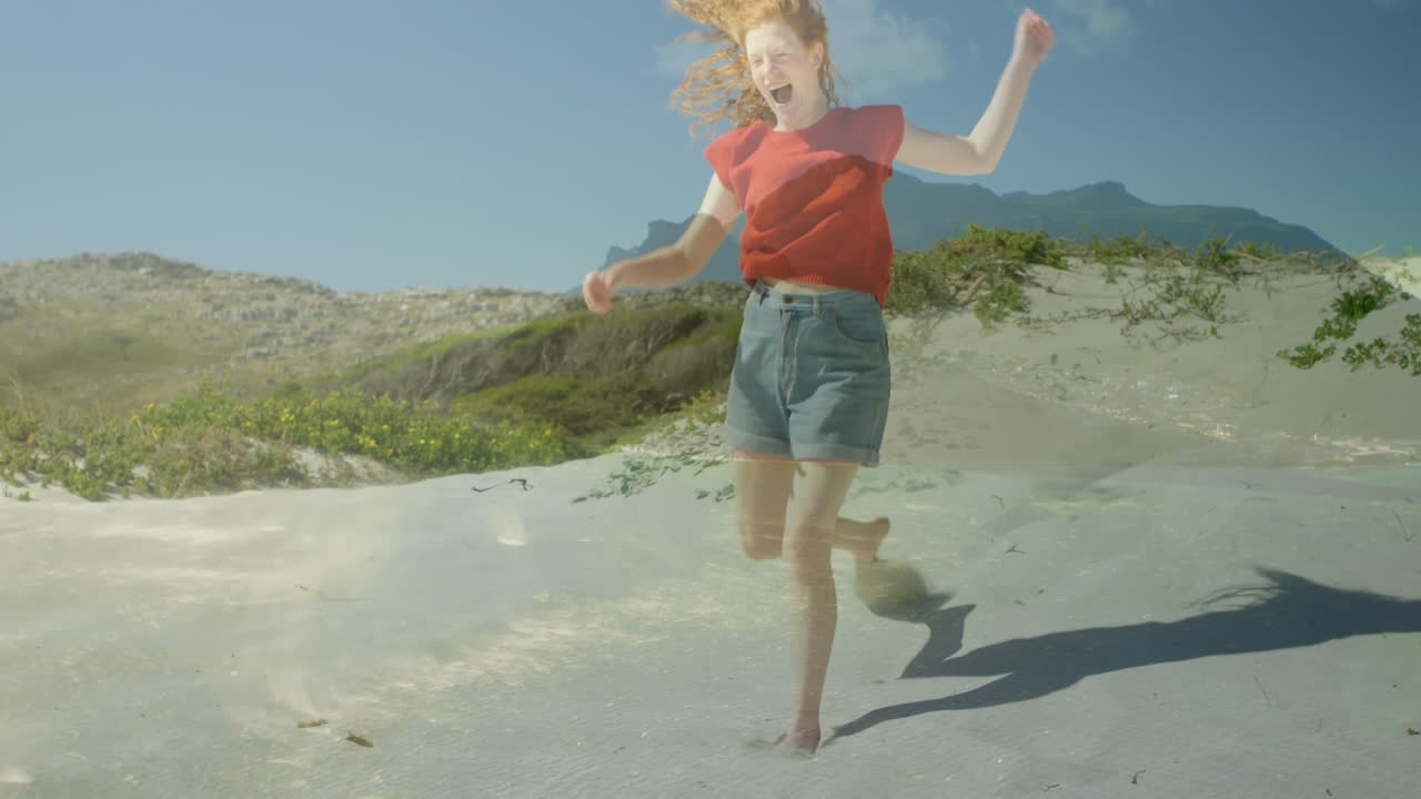 Animación de paisaje sobre mujer caucásica en la playa