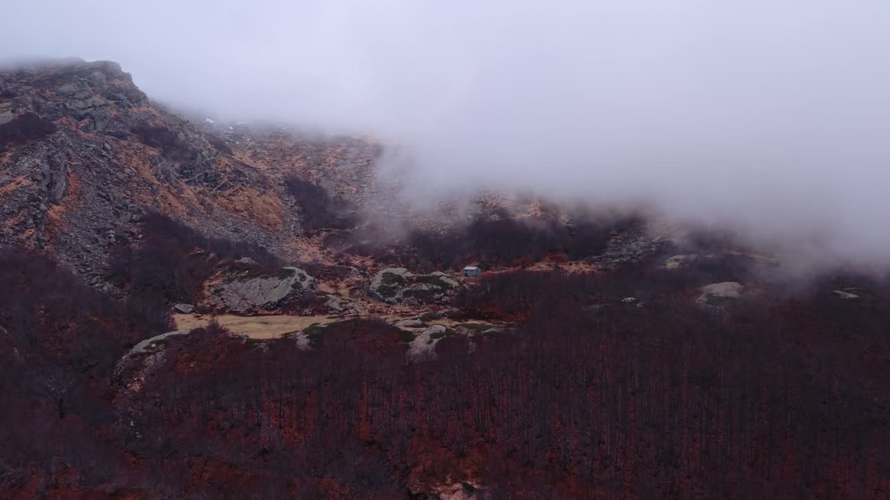 Stunning aerial view of rugged mountain terrain covered in mist in the Dolomites