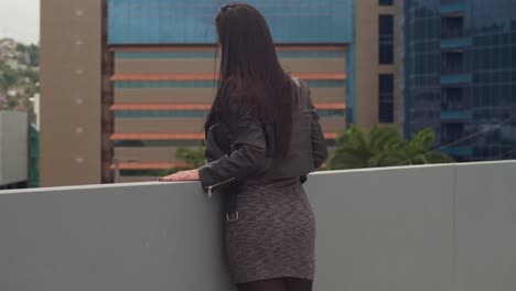on a rooftop overlooking the cityscape of port of spain, trinidad, a woman is having fun