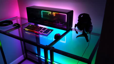 vibrant rgb gaming pc setup with colorful lighting on a glass desk