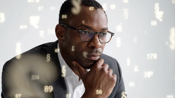 Contemplative Businessman Analyzing Financial Data Surrounded by Floating Currency Symbols and Numbers in a Reflective Moment of Strategic Thinking and Decision-Making