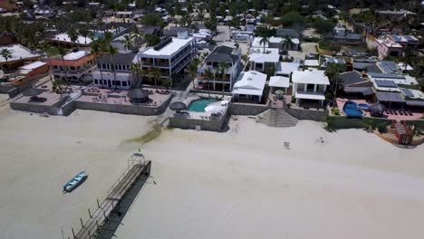 Beach-Houses-in-Coastal-Town-of-Baja-California-in-Mexico,-Aerial-Drone-Flying-View