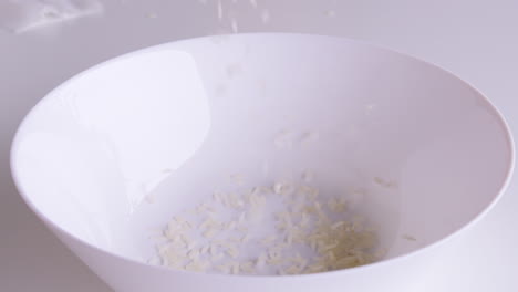 rice grains that have been cleaned of husks into bowls ready to be cooked and consumed, rice is the staple food of people in asia