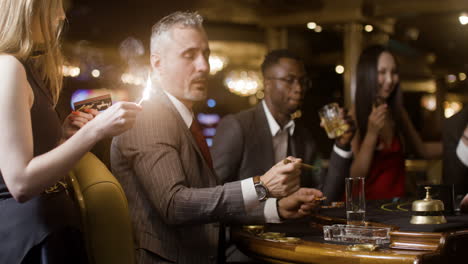 man having his cigar lit.