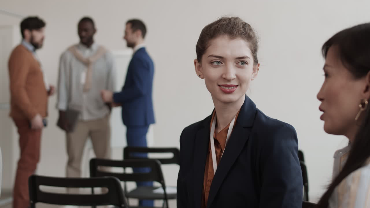 Female Coworkers Chatting and Smiling