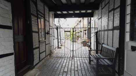 old gated alleyway in eton uk with bench by door