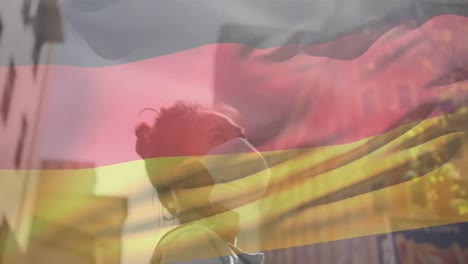 animación de la bandera de alemania ondeando sobre una mujer afroamericana con máscara facial en la calle de la ciudad