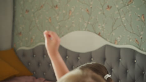 little children raise hands to answer question at home lesson