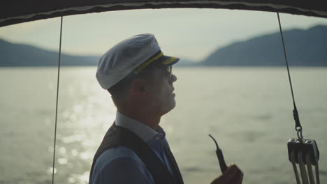 captain smoking a pipe on a yacht