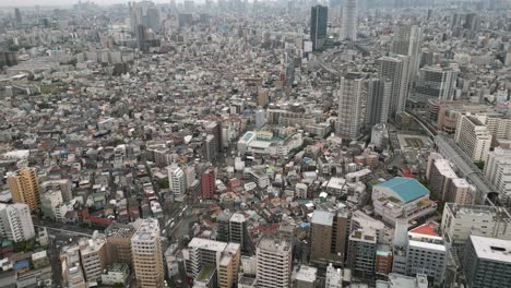 aerial scenic urban drone footage of a neighborhood, streets and buildings in the capital city of tokyo, japan