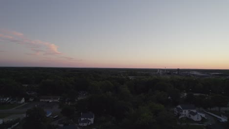 frontal tracking during dusk with drone in a small town near the forest