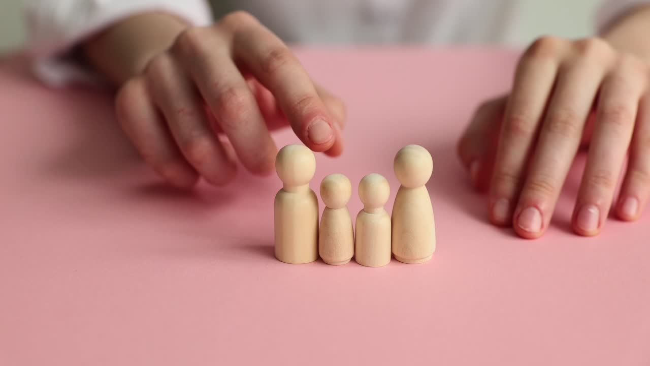 Wooden family figurines representing separation