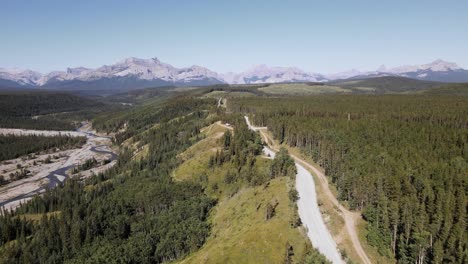 Vast,-endless-coniferous-forest-with-a-Rocky-Mountain-backdrop-on-a-sunny-day-in-Canada