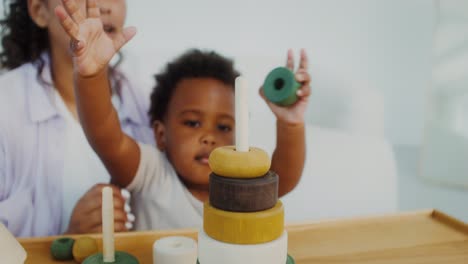 mother and child playing with stacking rings toy