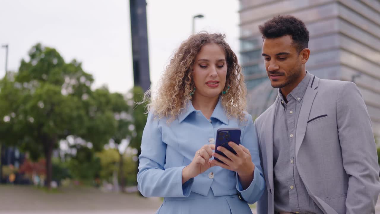 Business couple looking at phone