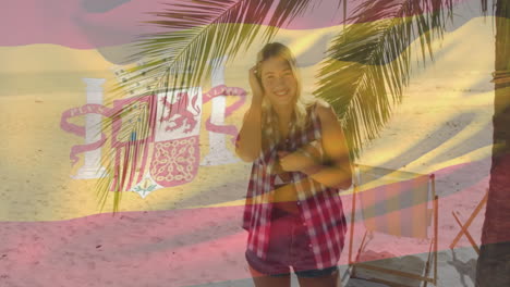 spanish flag animation over woman standing on beach near palm tree