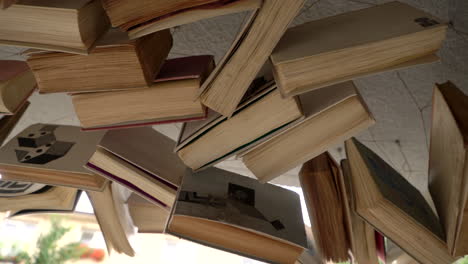 Old-books-hanging-on-a-ceiling-outside