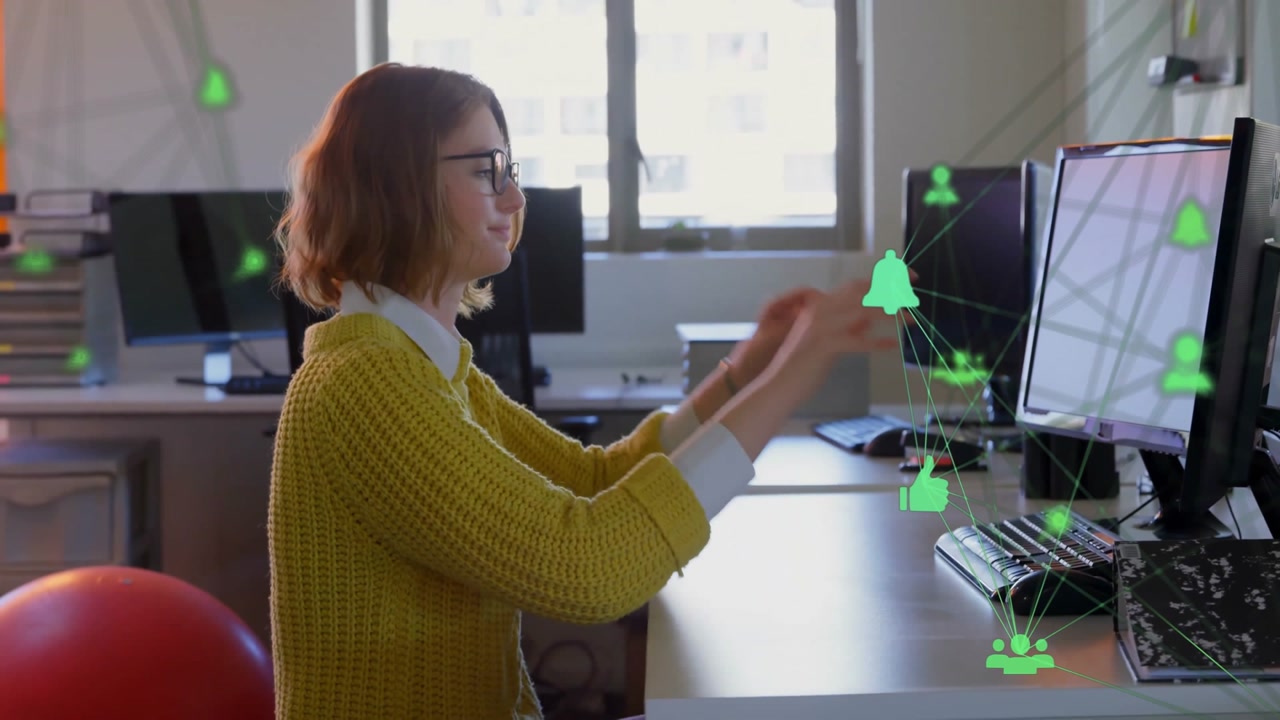Woman seated at desk typing at monitors in tech workspace, with animated network icons floating
