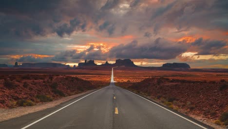 monument valley navajo national park cinemagraph seamless video loop at famous forrest gump running filming location highway street overlooking the red sand valley. clouds time-lapse at the famous movie landmark in utah, arizona, america usa.