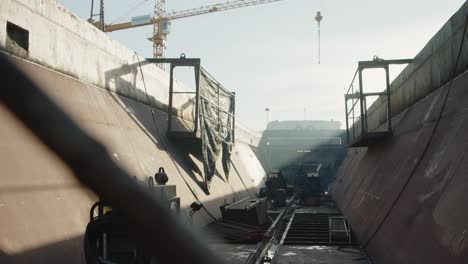 welding work being carried out inside ship cargo hull.