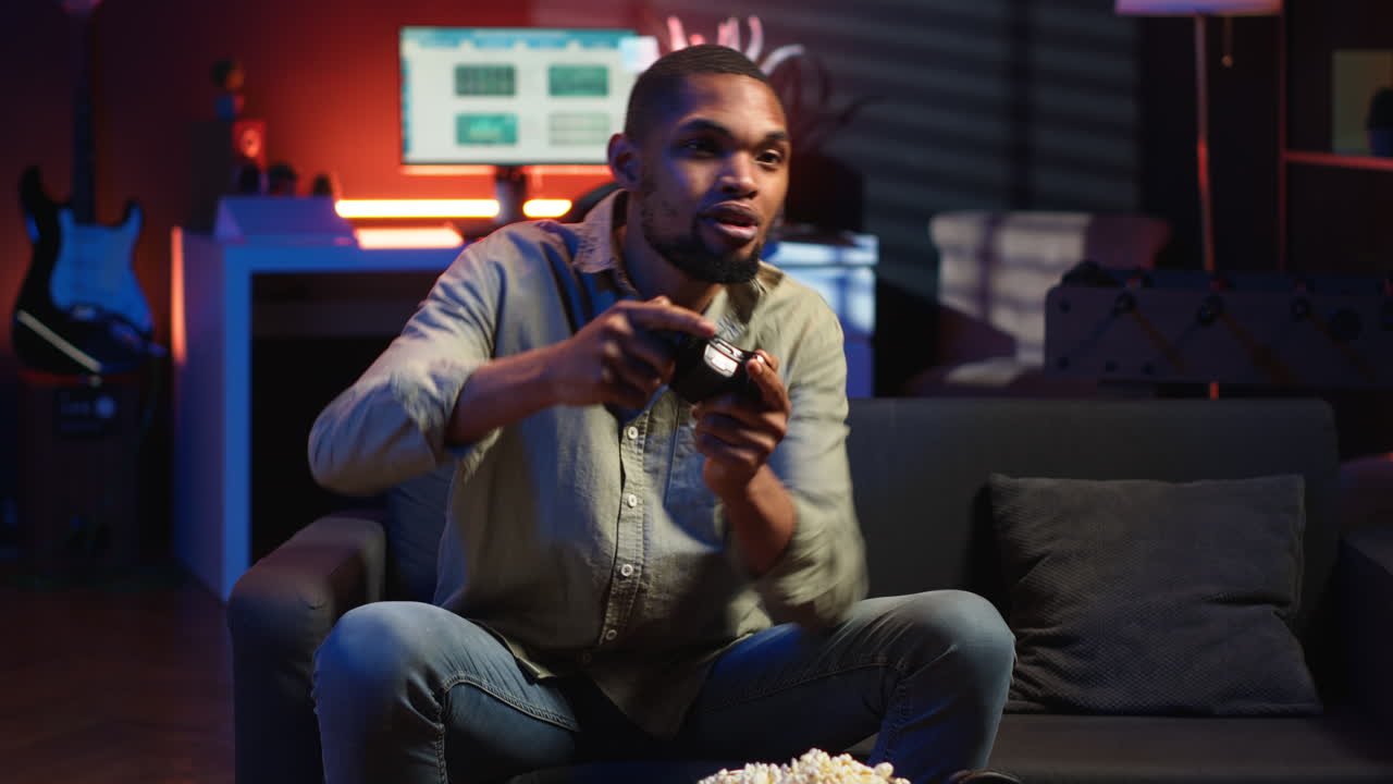 Vertical Video POV young black adult enjoying free time playing shooter games on smart tv