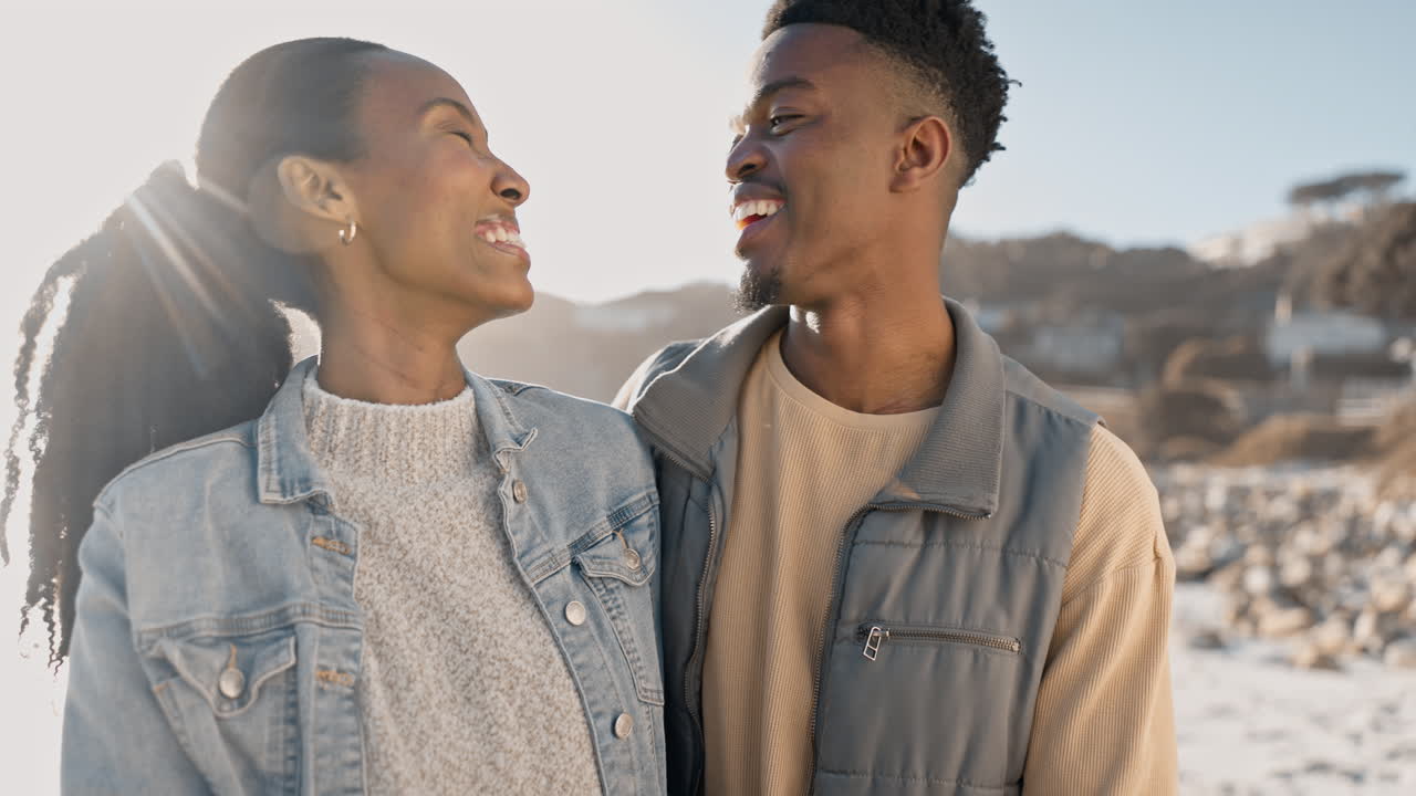 Black couple, ocean and laughing with love