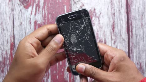 broken smartphone in hands