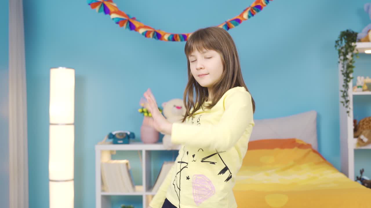 Dancer little girl performing dance show in her room at home.
