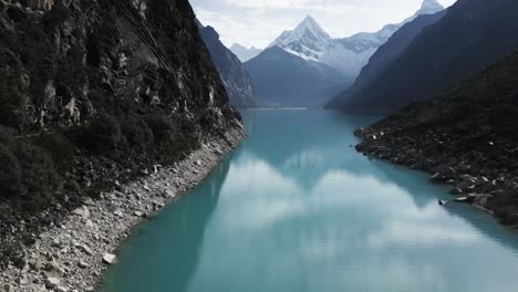 lake paron, pyramid mountain, aerial drone above water andean cordillera in peru huascaran national park, peruvian hiking destination