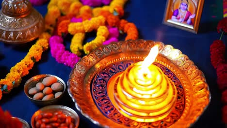 indian religious ceremony with diya and flowers