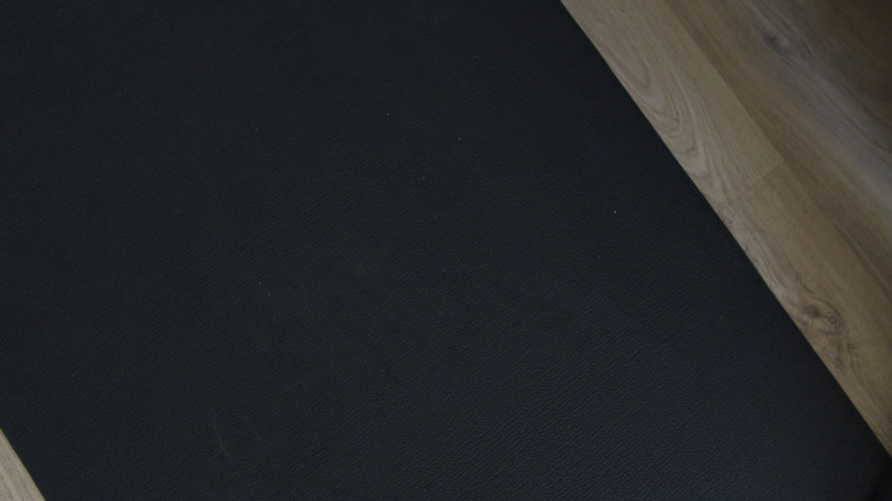 прекрасный замедленный снимок двух рук, поднимающих 2 веса, опирающихся на коврик для упражнений на полу, чтобы положить их обратно вниз