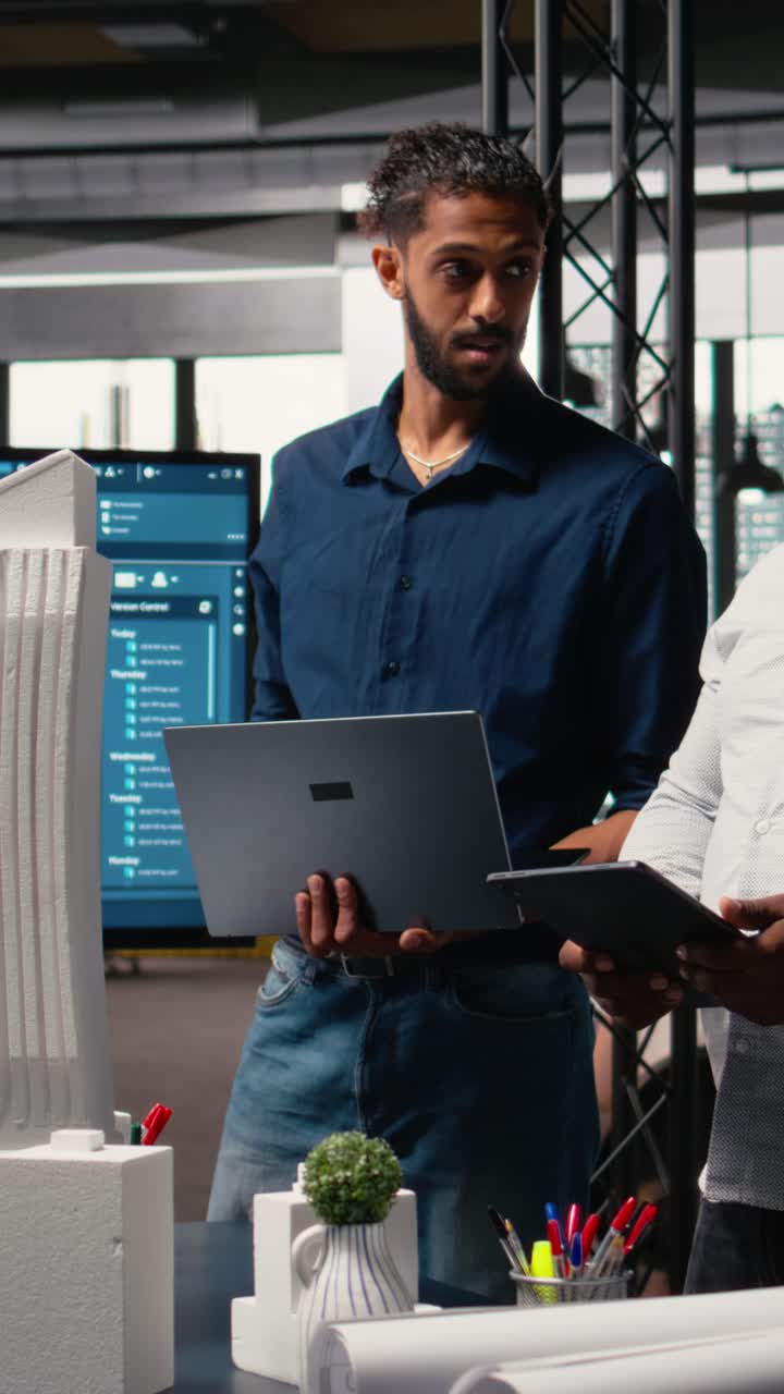 Vertical Video Multiethnic group of developers and contractors discussing urban housing models