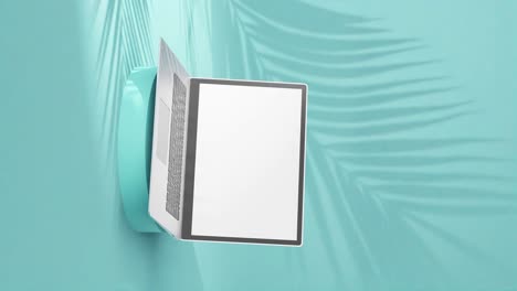 sleek silver laptop on round pedestal, empty screen with palm tree shadows on light blue background, vertical