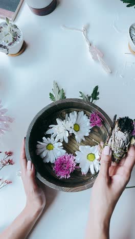 smudging ceremony with flowers and crystals