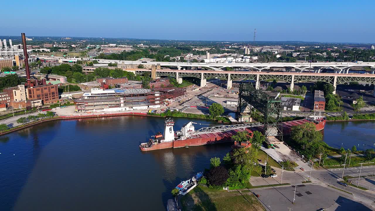 Freighter passes through Collision Bend on Cuyahoga River in Cleveland, Ohio with closed steam plant in background