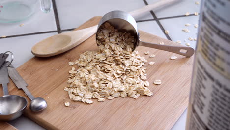 a pile of oats grain cereal with kitchen utensils for a healthy oatmeal breakfast