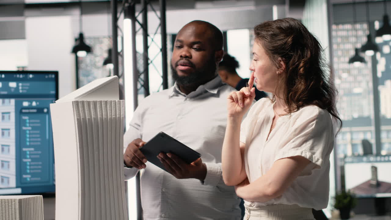 Vertical Video Multiethnic engineers uniting forces for residential project layout