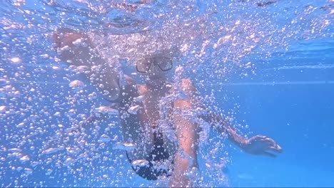 a young swimmer dives beneath the surface, wearing a mask and fins, surrounded by shimmering bubbles and vibrant light. joy and curiosity radiate as he enjoys the water