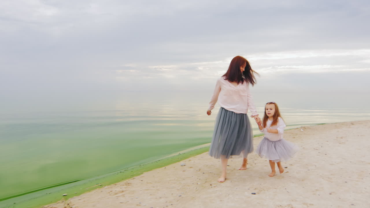 Carefree Mother And Daughter Three Years Running By The Beach