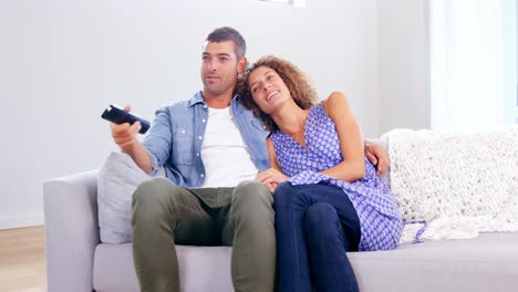 cute young couple watching tv