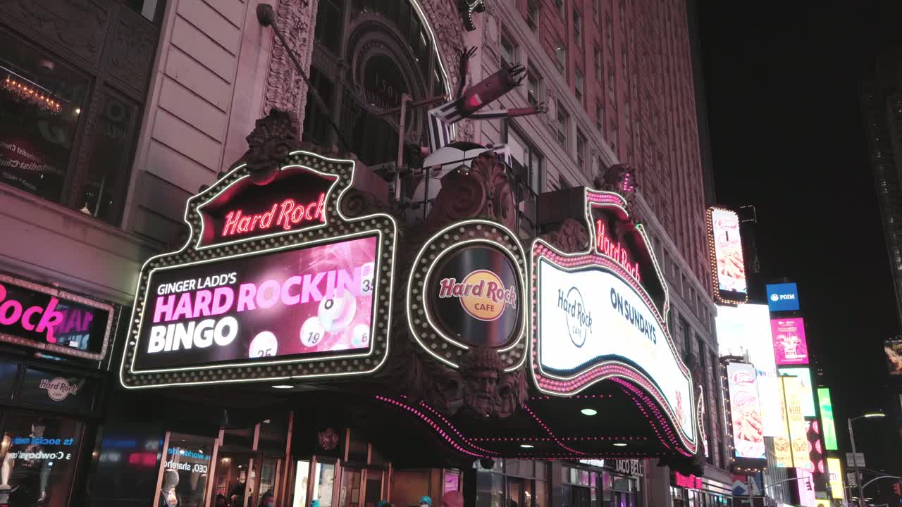 Shining hard rock cafe entrance - New york city at night light camera movement