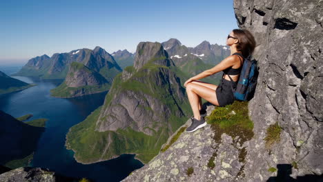 hiker enjoys panoramic views of stunning fjords and mountains