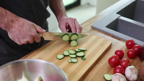Slicing cucumber on a cutting board