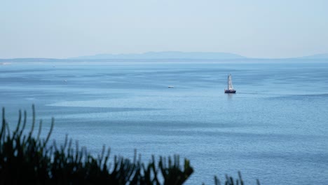 Ocean-Landscape-of-Sailboat-on-Estoril-Bay-in-Portugal,-Sunny-Day